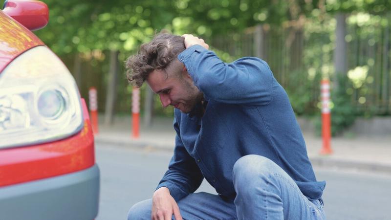 Young male driver after a fender bender