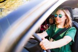 Portrait happy, smiling woman sitting in the car looking out windows.jpg