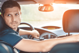 Portrait happy, smiling woman sitting in the car looking out windows.jpg