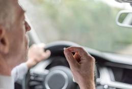 Portrait happy, smiling woman sitting in the car looking out windows.jpg