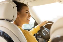 Portrait happy, smiling woman sitting in the car looking out windows.jpg