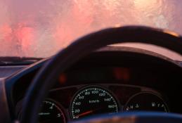 Portrait happy, smiling woman sitting in the car looking out windows.jpg